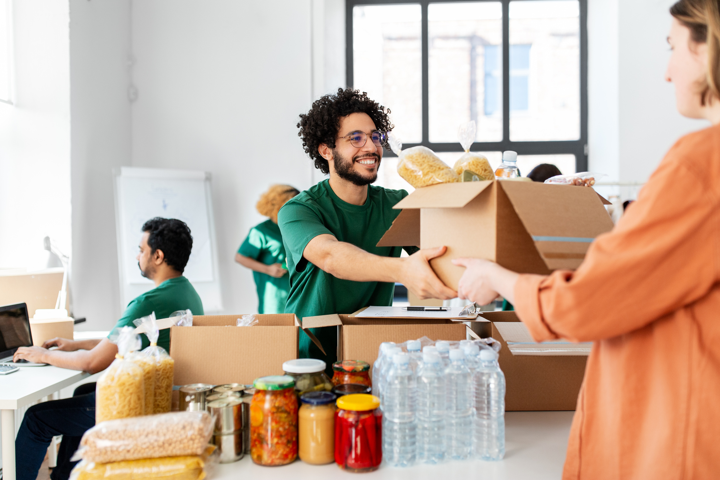 Volunteer Giving Food at Refugee Assistance Center